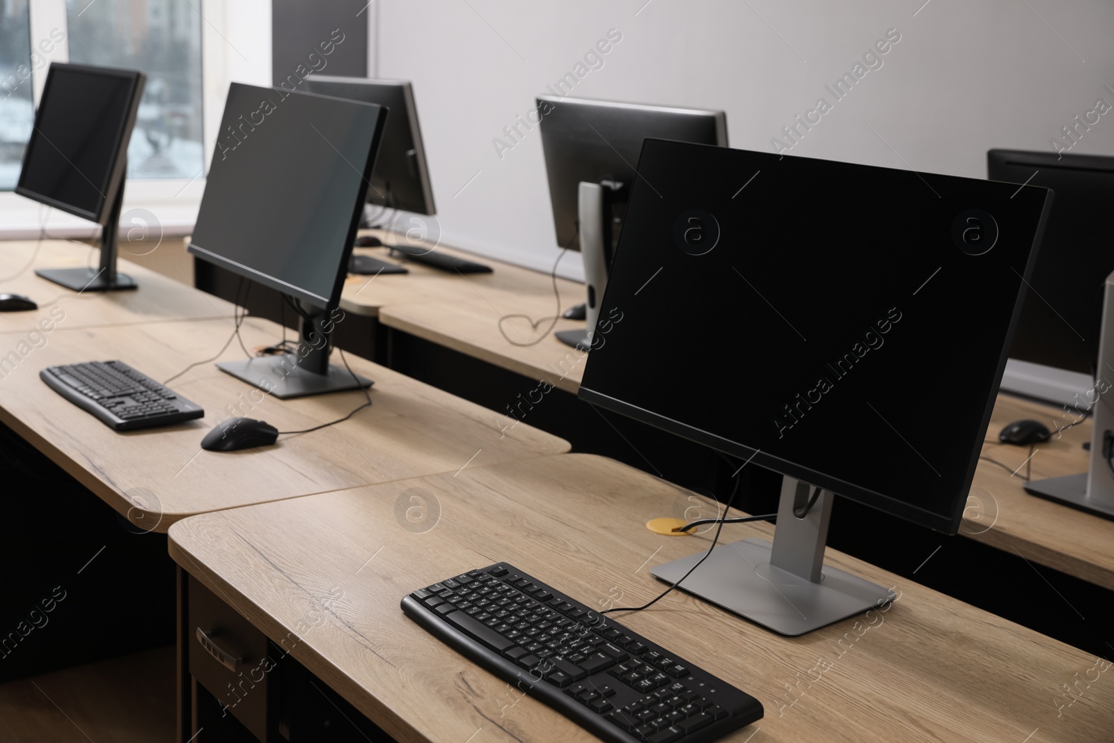 Photo of Many modern computers in open space office