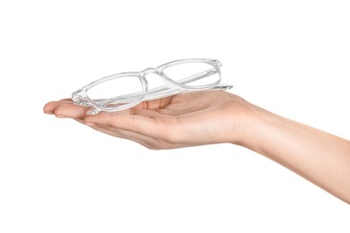 Woman holding glasses with transparent frame on white background, closeup