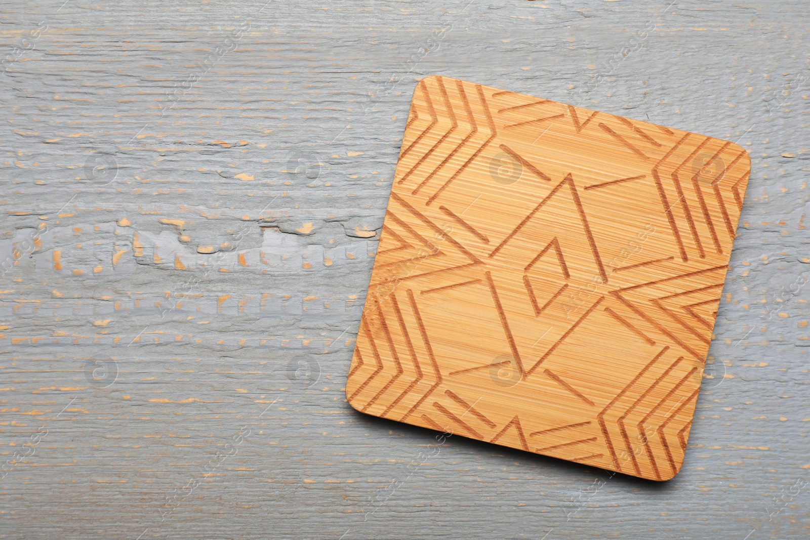 Photo of Stylish cup coaster on grey wooden table, top view Space for text