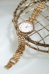 Photo of Stylish presentation of elegant wristwatch on white background, closeup