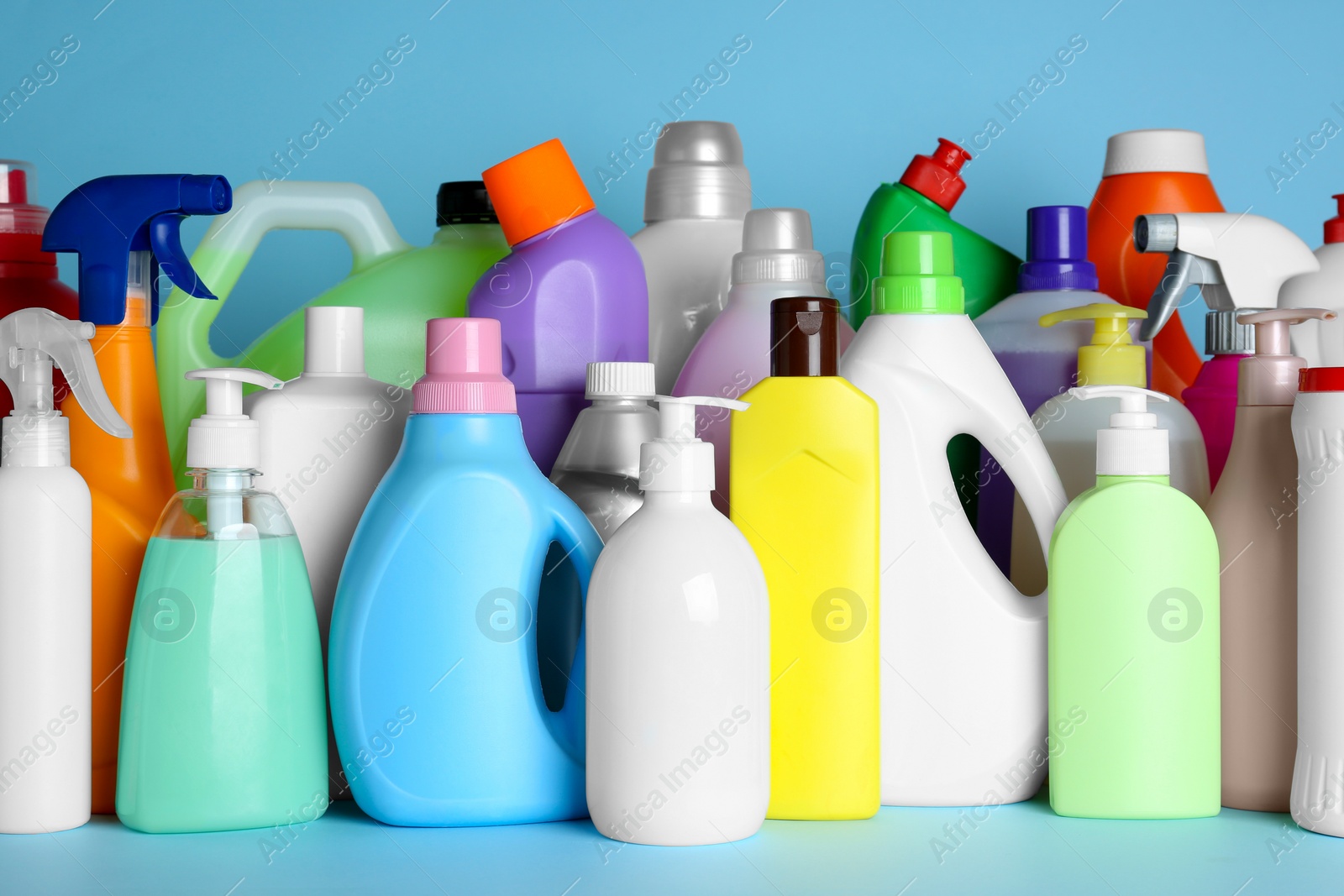 Photo of Many different cleaning supplies on light blue background