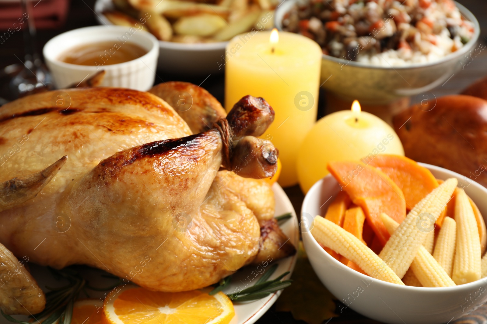 Photo of Traditional Thanksgiving day feast with delicious cooked turkey and other seasonal dishes served on table, closeup