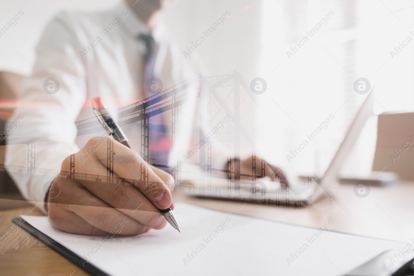 Image of Double exposure of architect working at table and view of bridge