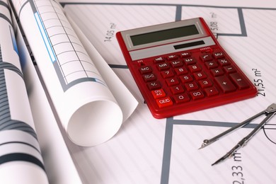 Photo of Construction drawings, calculator and dividers, closeup view