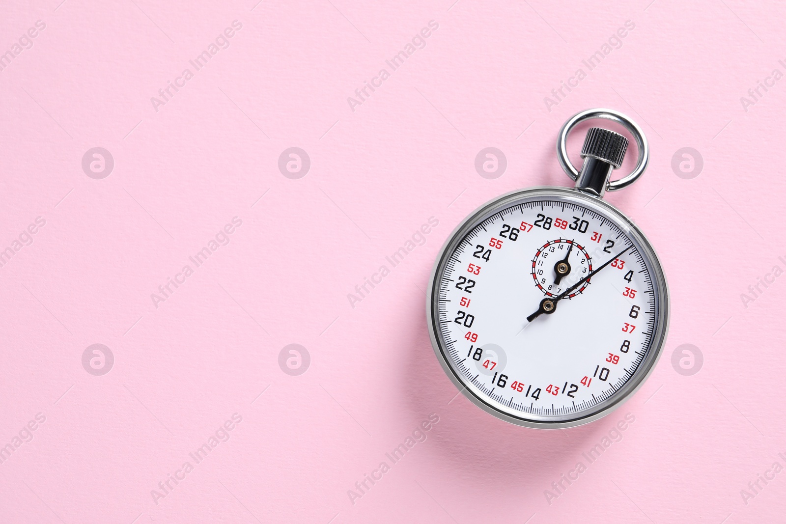 Photo of Vintage timer on pink background, top view with space for text. Measuring tool