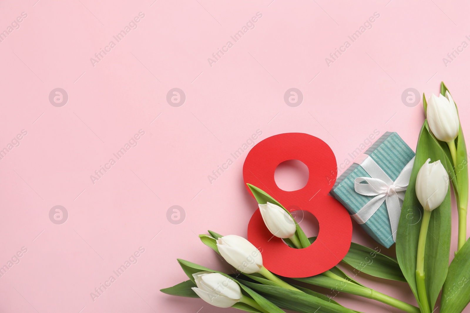 Photo of 8 March card design with tulips, gift and space for text on pink background, flat lay. International Women's Day
