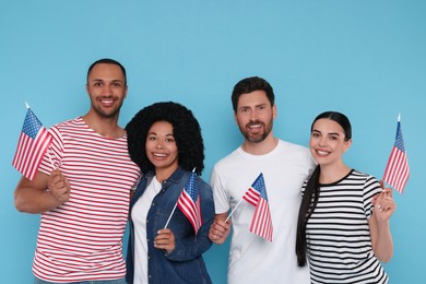 Photo of 4th of July - Independence Day of USA. Happy friends with American flags on light blue background