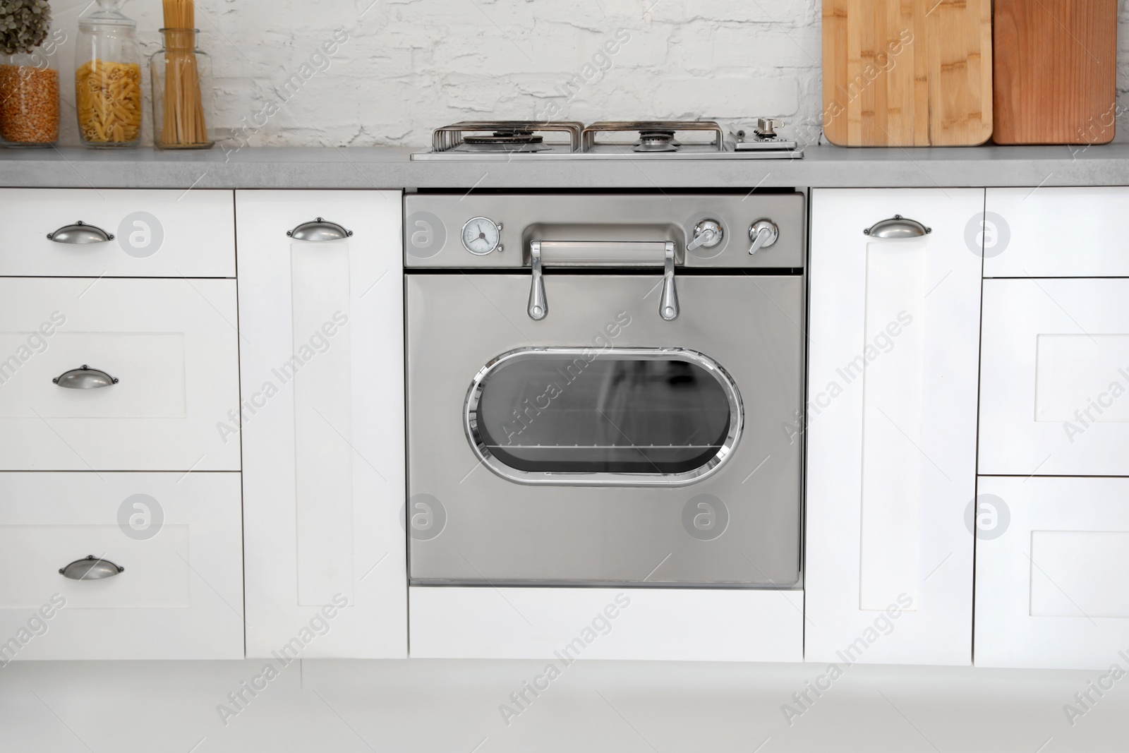 Photo of New modern oven in stylish kitchen. Cooking appliance