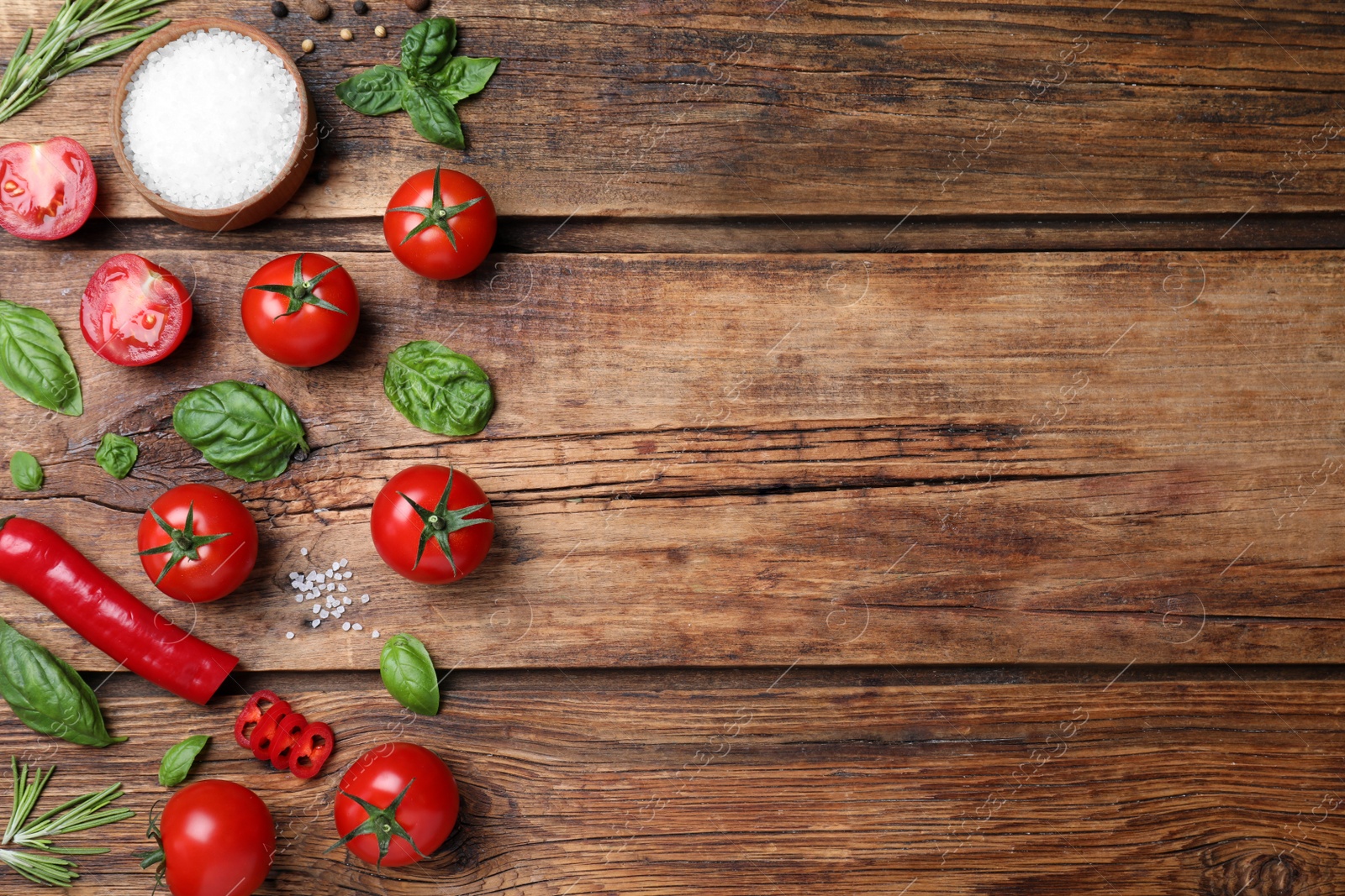 Photo of Flat lay composition with fresh green basil leaves on wooden table, space for text