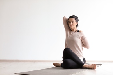 Sporty woman practicing yoga indoors