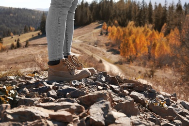 Photo of Female traveler standing on ground in mountains