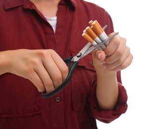 Photo of Stop smoking concept. Woman cutting cigarettes on white background, closeup