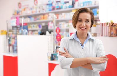 Portrait of professional pharmacist in modern drugstore, space for text