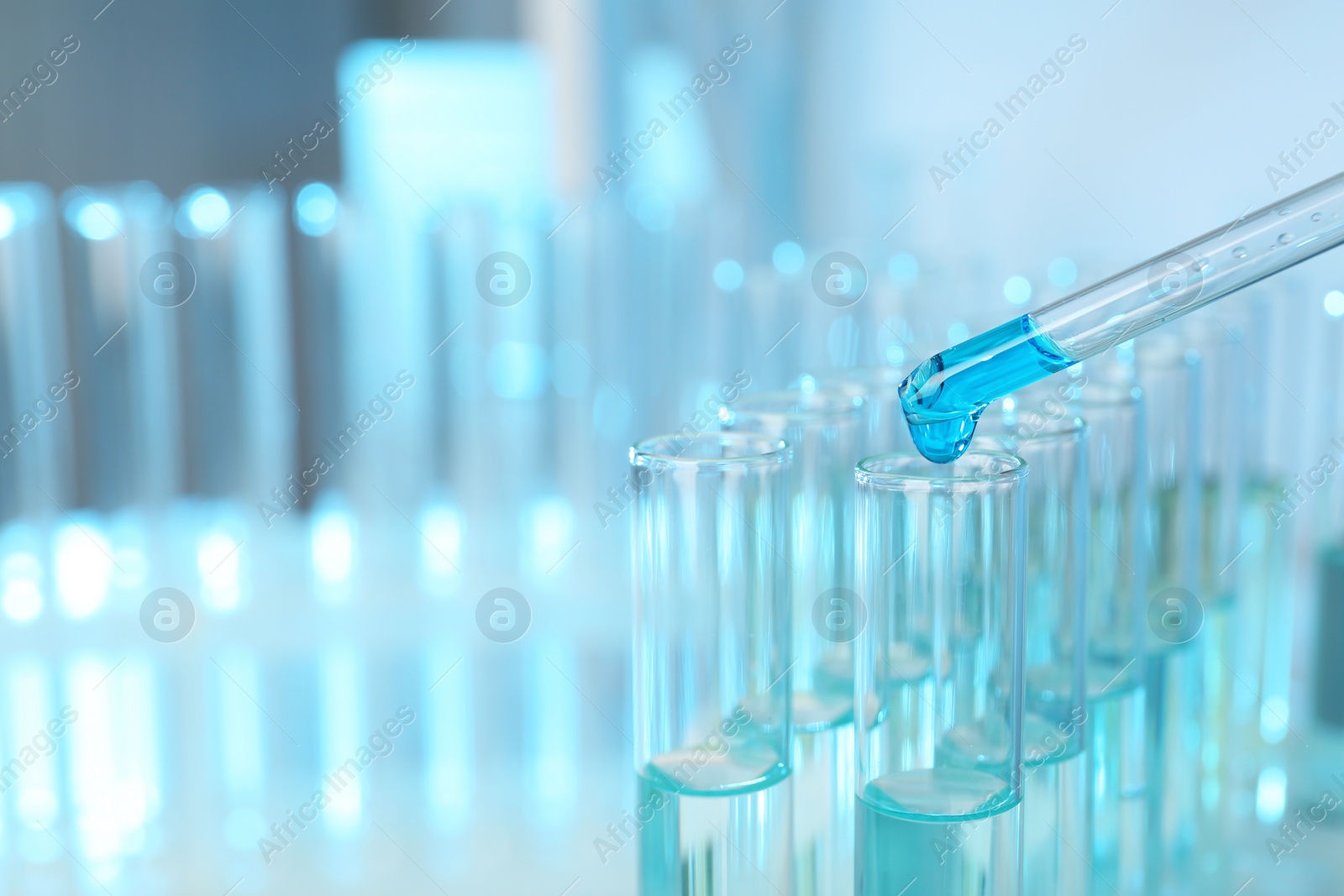 Photo of Dripping reagent into test tube with sample at laboratory, closeup. Chemical analysis