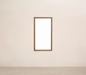 Photo of Frame with empty canvas on wall in modern art gallery. Mockup for design