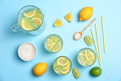 Photo of Flat lay composition with delicious natural lemonade on color background