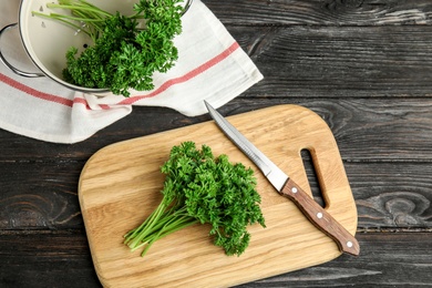 Photo of Flat lay composition with fresh green parsley on dark wooden table