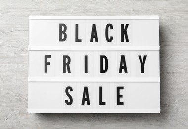 Lightbox with words Black Friday Sale on wooden table, top view