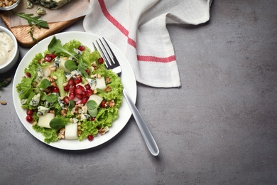 Photo of Fresh salad with pear served on grey table, flat lay. Space for text