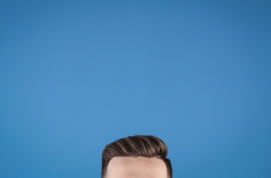 Photo of Man with beautiful hair on color background, closeup