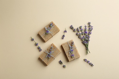 Photo of Flat lay composition of handmade soap bars with lavender flowers on beige background
