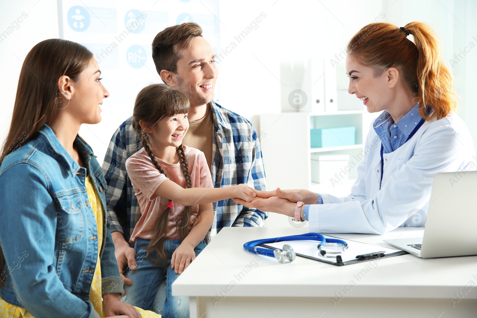 Photo of Family with child visiting doctor in hospital