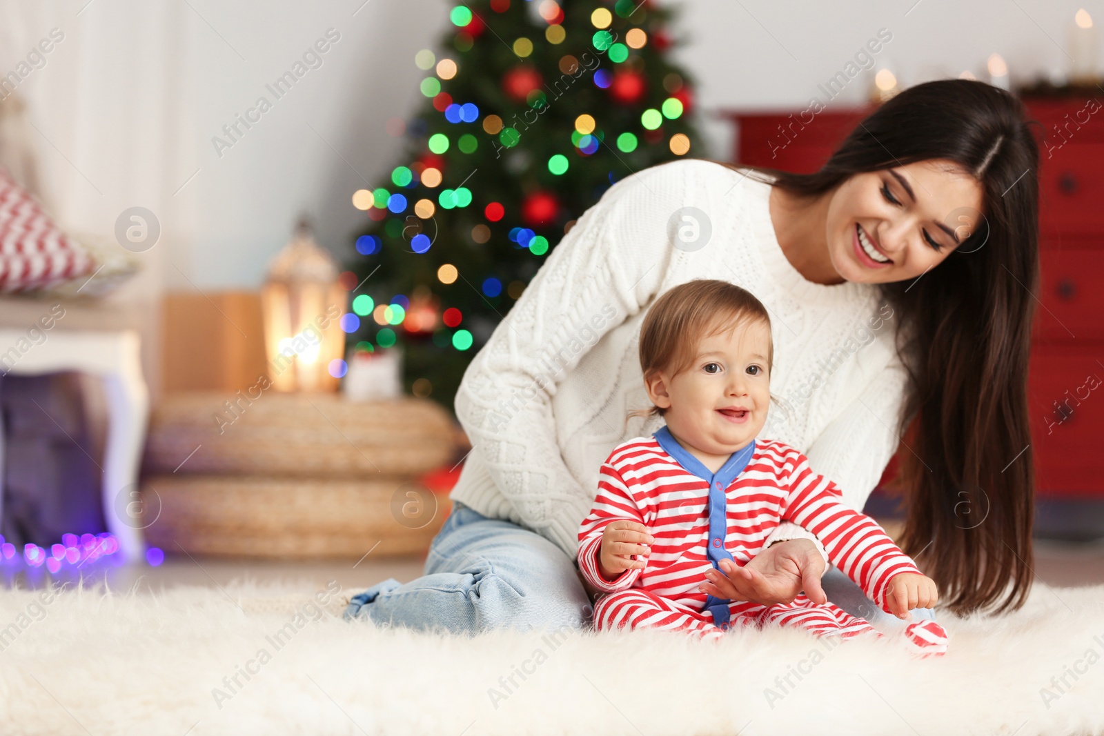 Photo of Mother and her cute baby at home. Christmas celebration