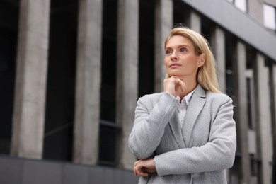 Portrait of thoughtful woman outdoors, space for text. Lawyer, businesswoman, accountant or manager