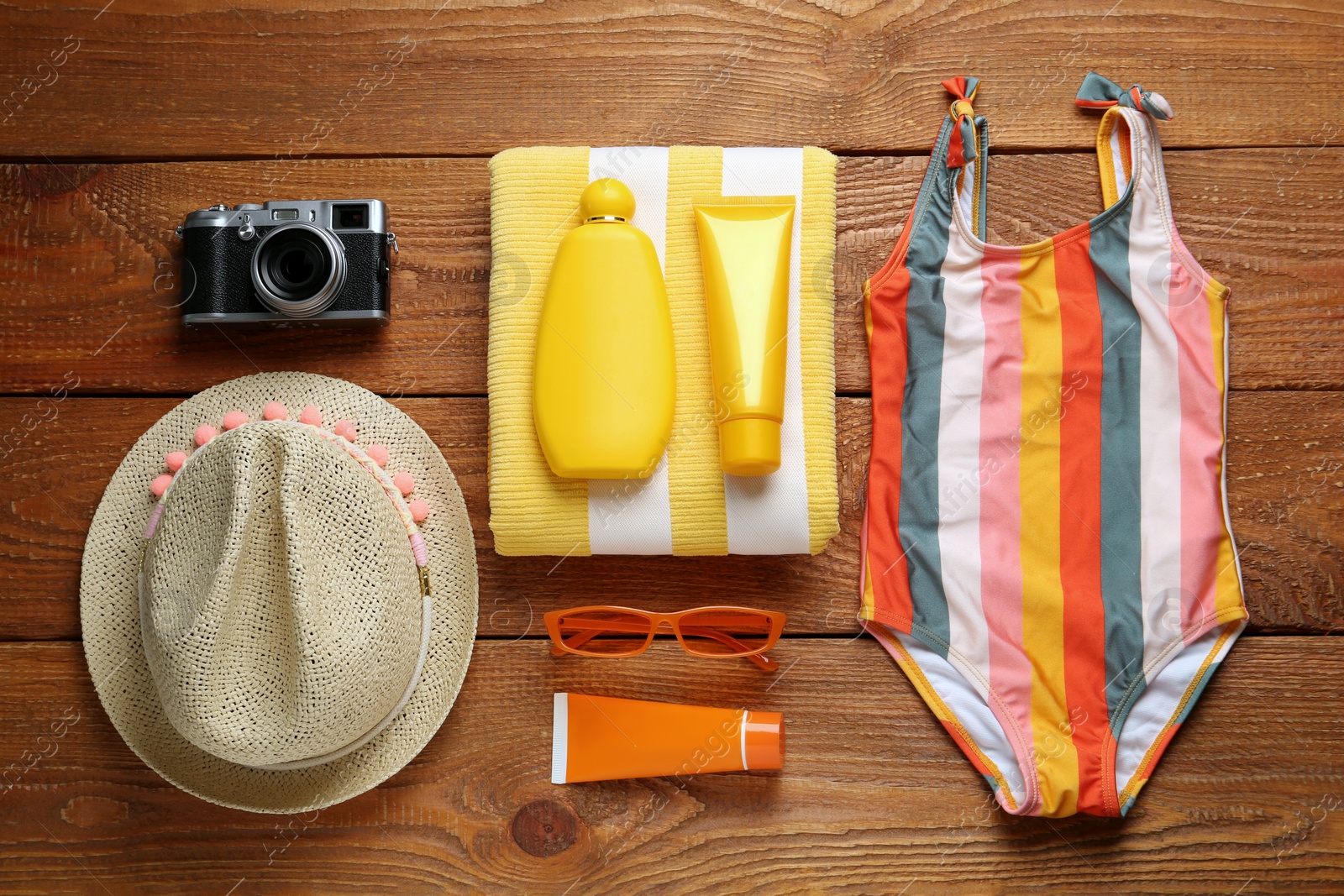 Photo of Different beach objects on wooden background, flat lay