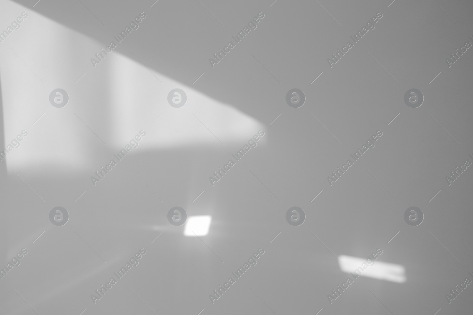 Image of Light and shadows falling on white wall