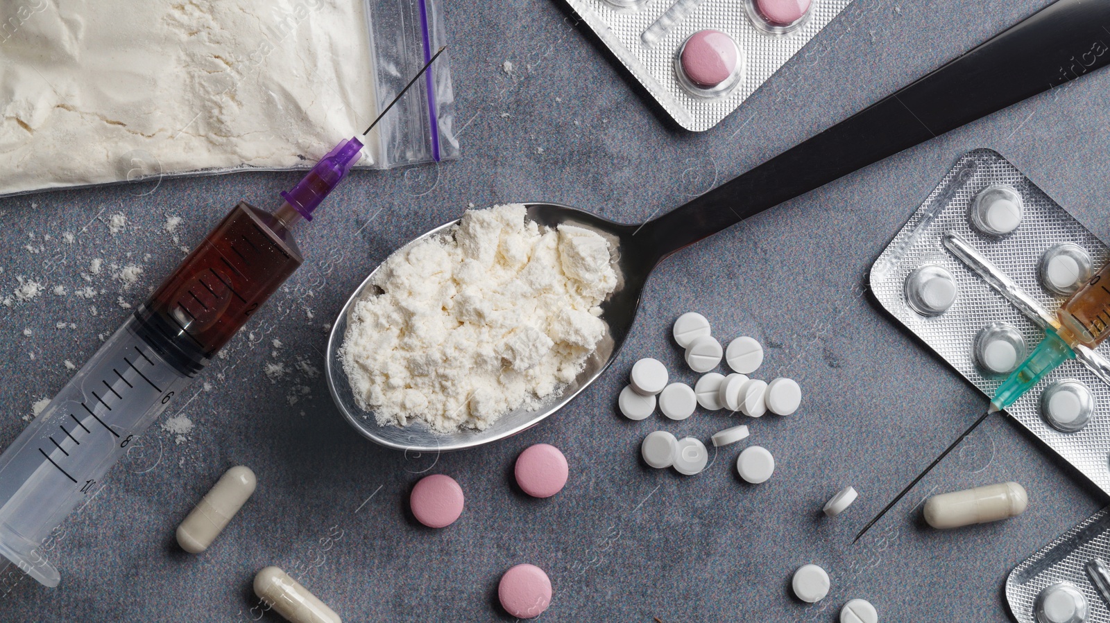 Photo of Different hard drugs on light grey table, flat lay