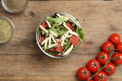 Photo of Delicious carrot salad served on wooden table, flat lay