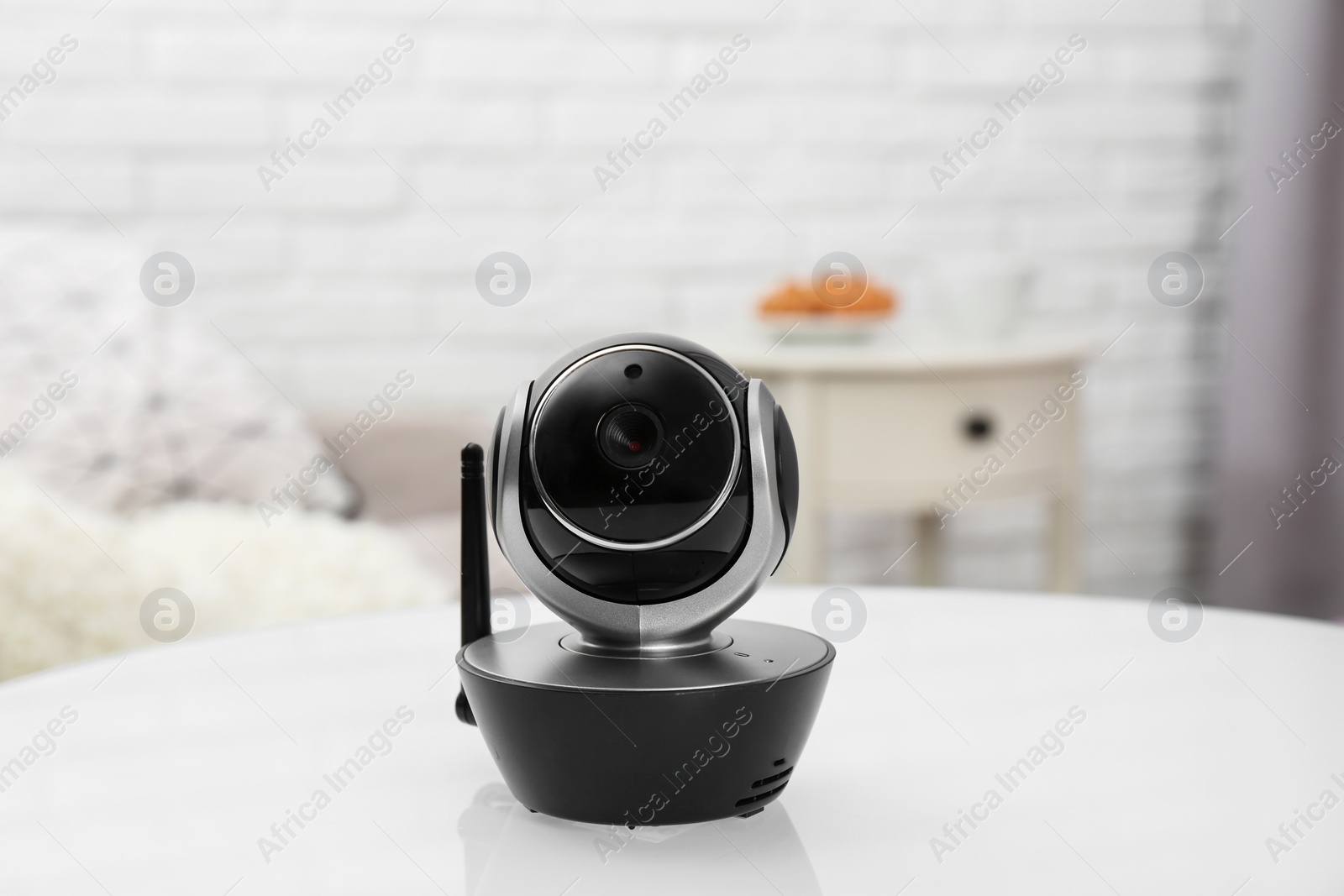 Photo of Modern CCTV security camera on table indoors