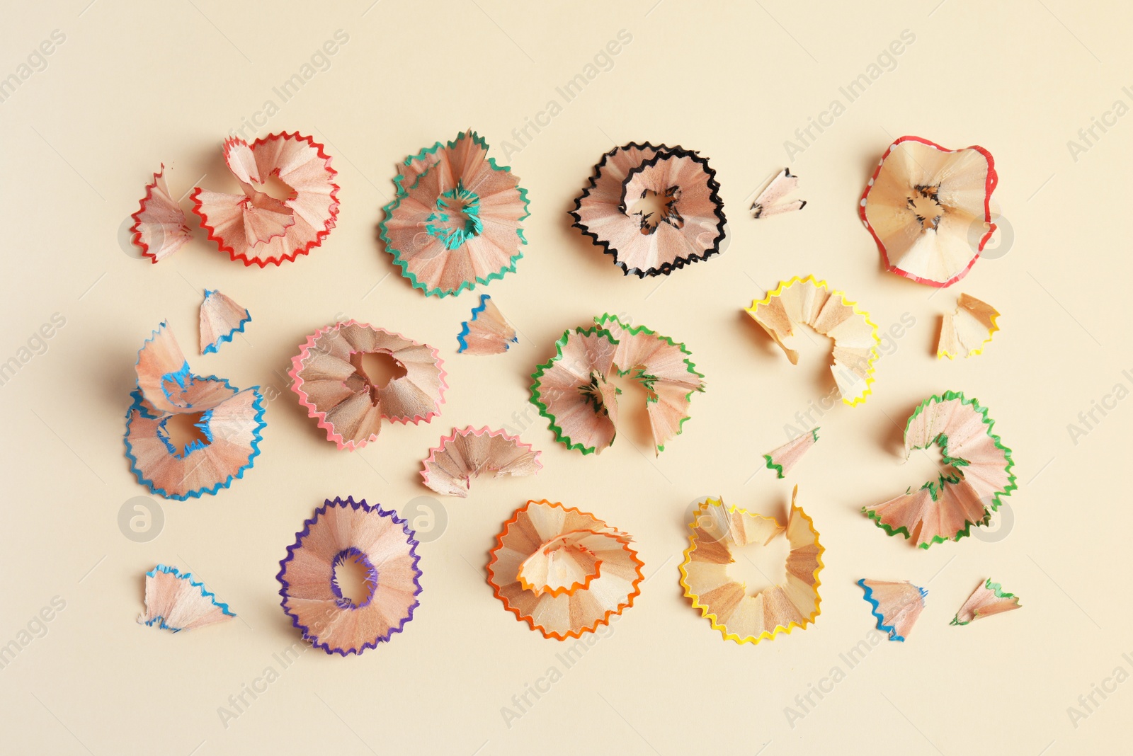 Photo of Pencil shavings on beige background, flat lay
