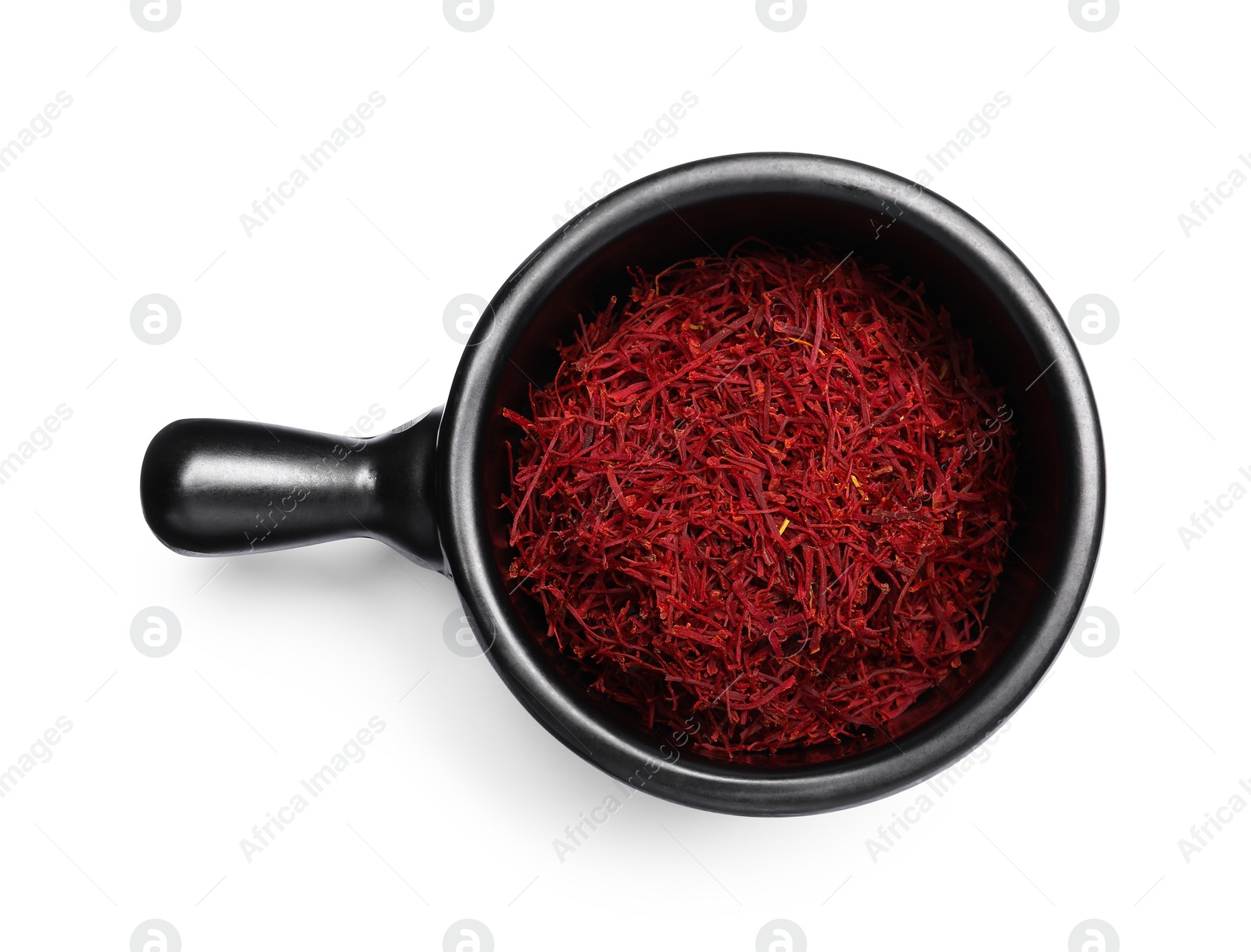 Photo of Aromatic saffron in dish isolated on white, top view