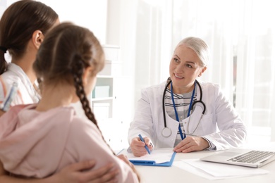 Photo of Mother with child visiting doctor in hospital