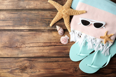 Photo of Flat lay composition with sunglasses on wooden background, space for text. Beach objects