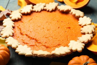 Photo of Delicious homemade pumpkin pie on blue wooden table, closeup