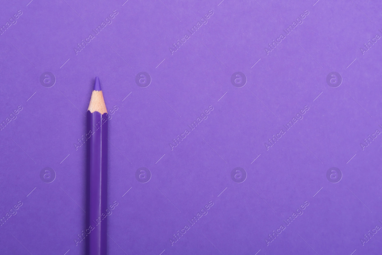 Photo of Colorful pencil on purple background, top view. Space for text