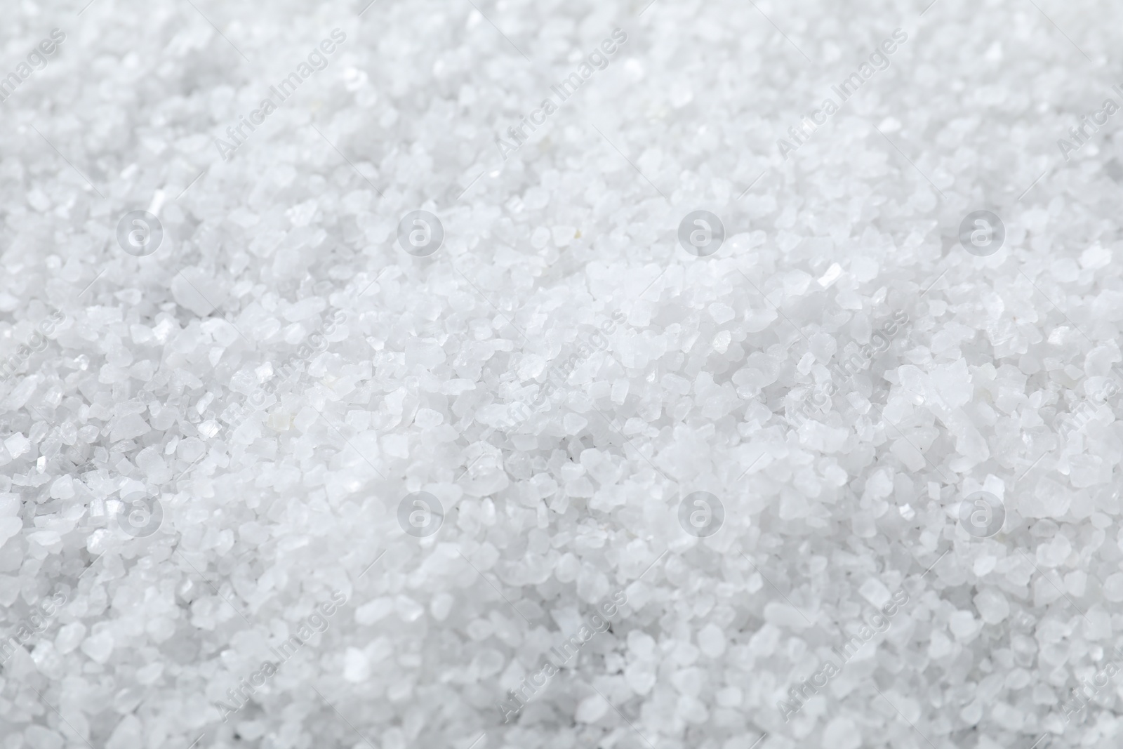 Photo of White natural salt as background, closeup view