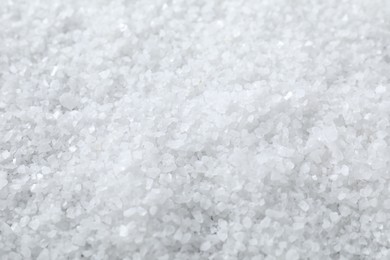 Photo of White natural salt as background, closeup view