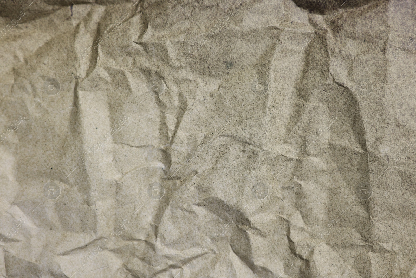 Photo of Texture of crumpled parchment paper as background, top view