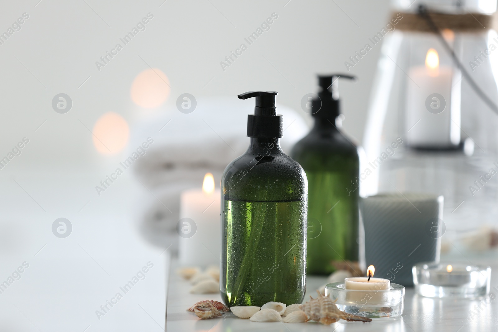 Photo of Soap dispensers and decor elements on table. Space for text