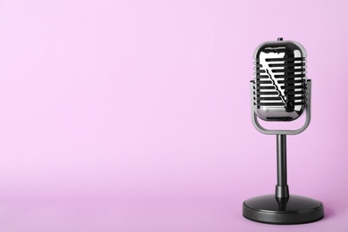 Photo of Retro microphone on color background, space for text