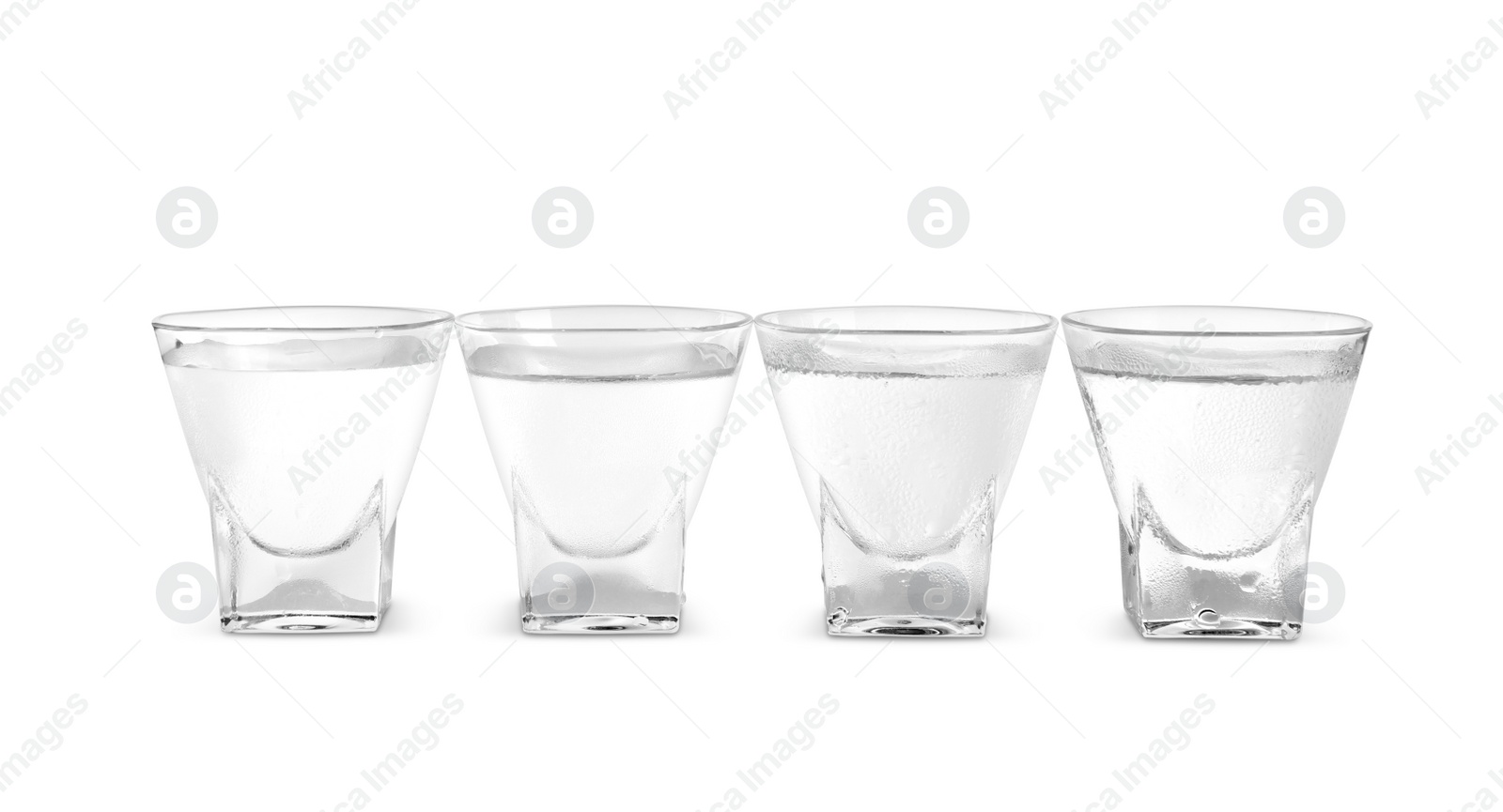 Photo of Vodka in shot glasses on white background