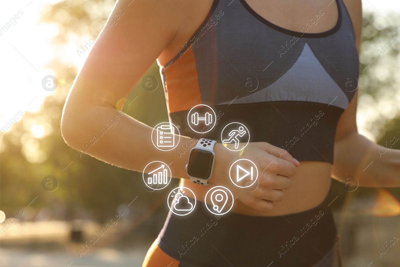 Image of Woman wearing fitness tracker during training outdoors, closeup