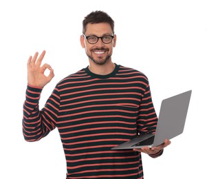 Photo of Smiling man with laptop showing okay gesture on white background