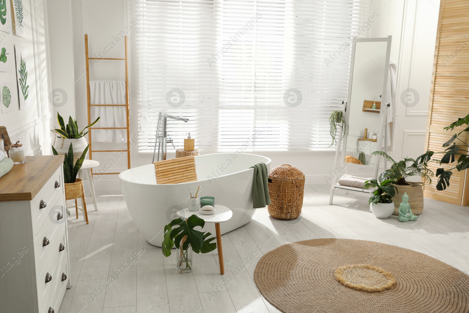 Photo of Stylish bathroom interior with green plants. Home design