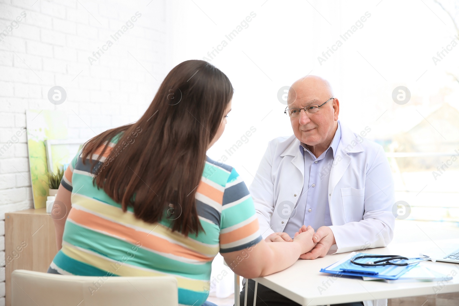 Photo of Overweight woman having consultation at doctor's office