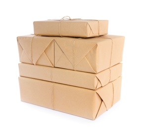 Stacked parcels wrapped in kraft paper on white background